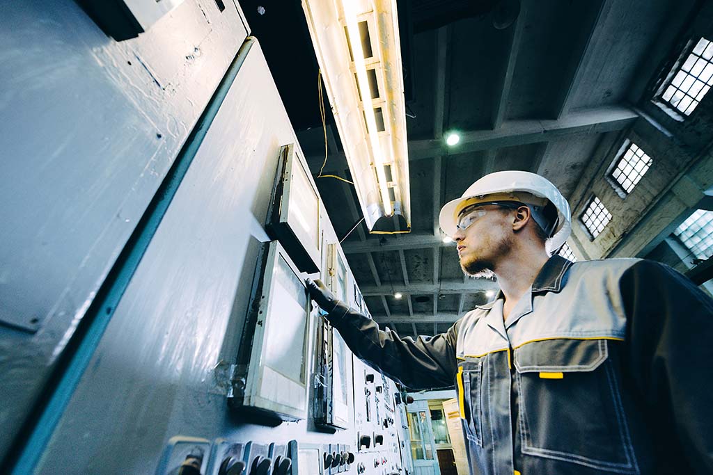 A power plant worker checking monitors.