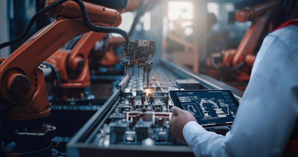 An engineer tests the control of a robot arm