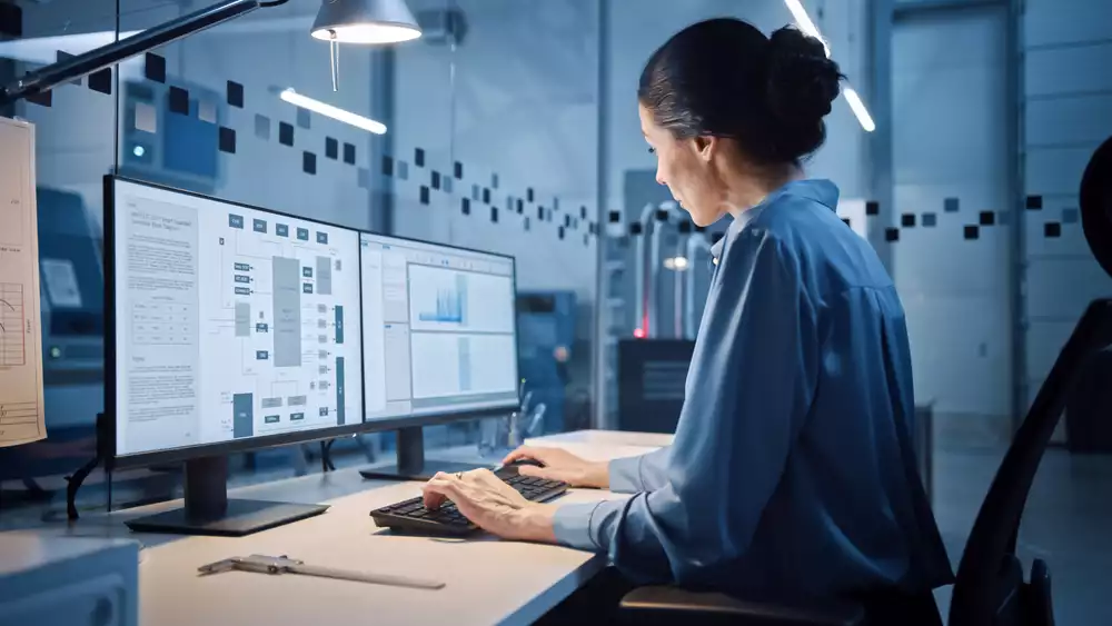 An engineer working on a computer in a factory office