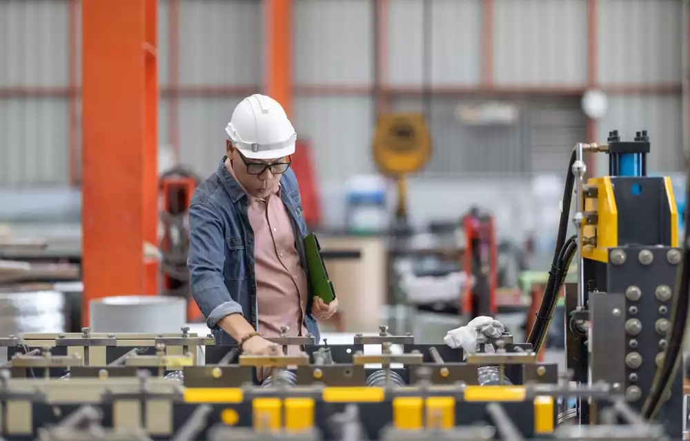 A factory supervisor reviewing equipment