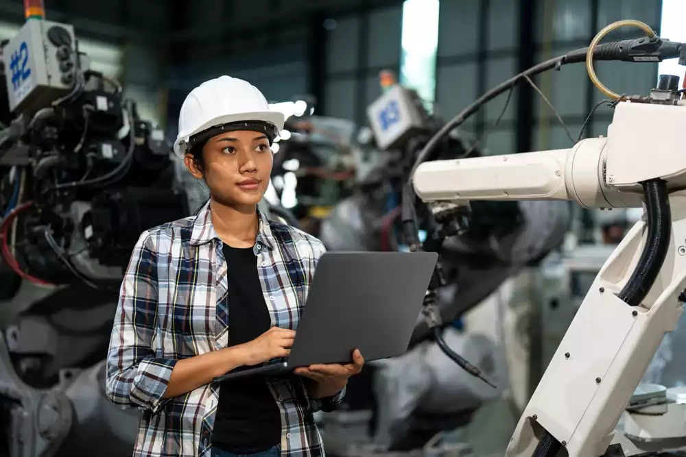 An engineer checking a robotic arm
