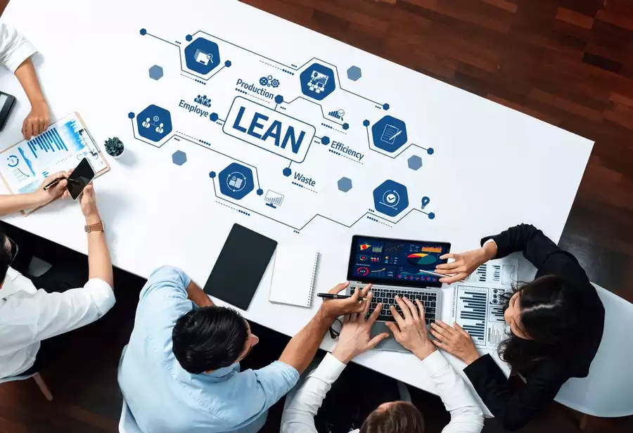 Photo of a diverse team working on improving their lean manufacturing system