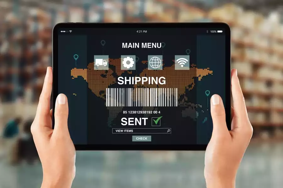 Hands holding a tablet displaying logistics tracking